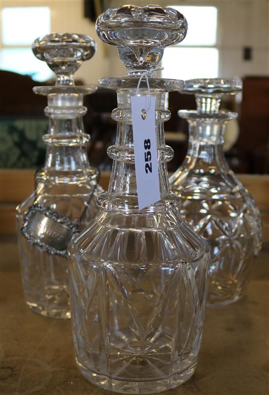Pair Victorian cut glass decanters and stoppers and one other decanter and stopper